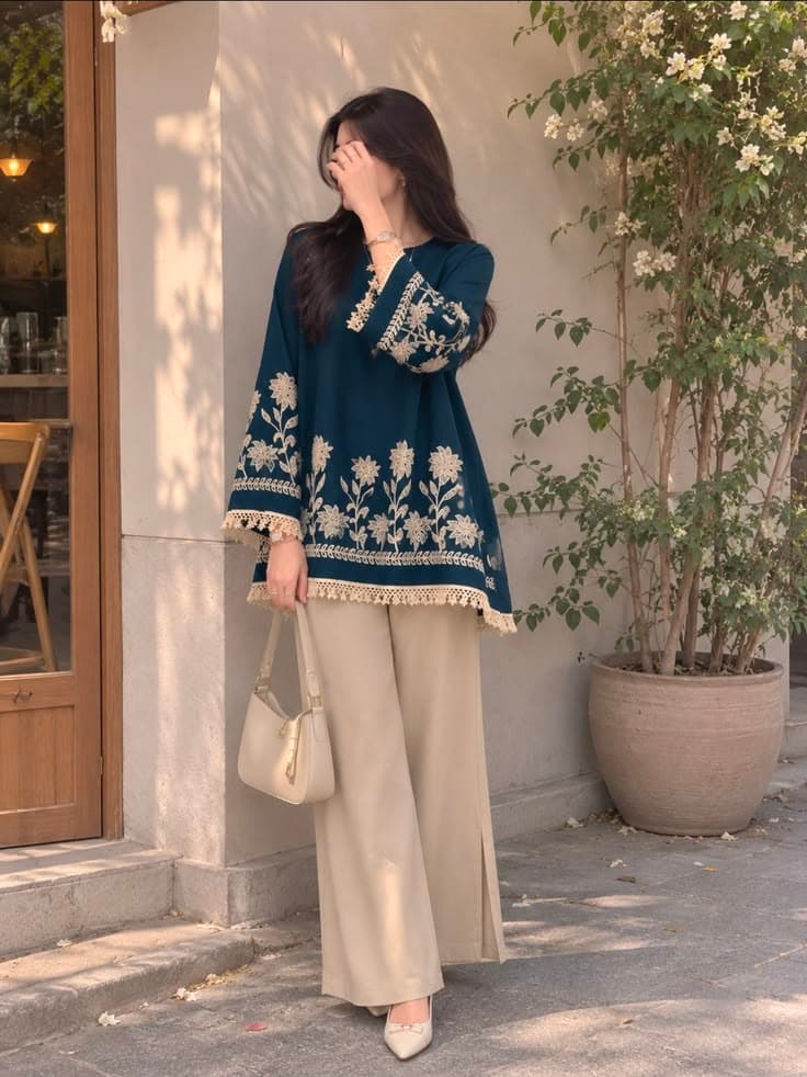 Navy embroidered tunic with beige wide-leg pants for rental